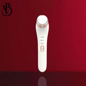 "White eye massager with gold accents, labeled buttons for clean, moist, and cool functions, on a red background."