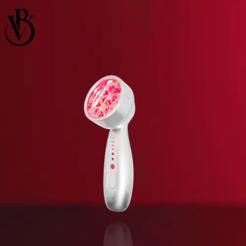 "White LED light therapy facial device with a circular red light head and control buttons, set against a red background."