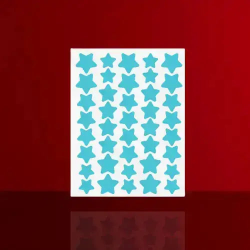 "Sheet of aqua star-shaped acne patches with a white backing, arranged in a grid pattern on a red background."