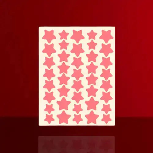 Sheet of cute star acne patches in various shades of pink, arranged in a grid pattern on a light background.