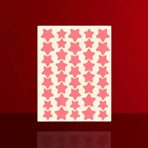 Sheet of cute star acne patches in various shades of pink, arranged in a grid pattern on a light background.