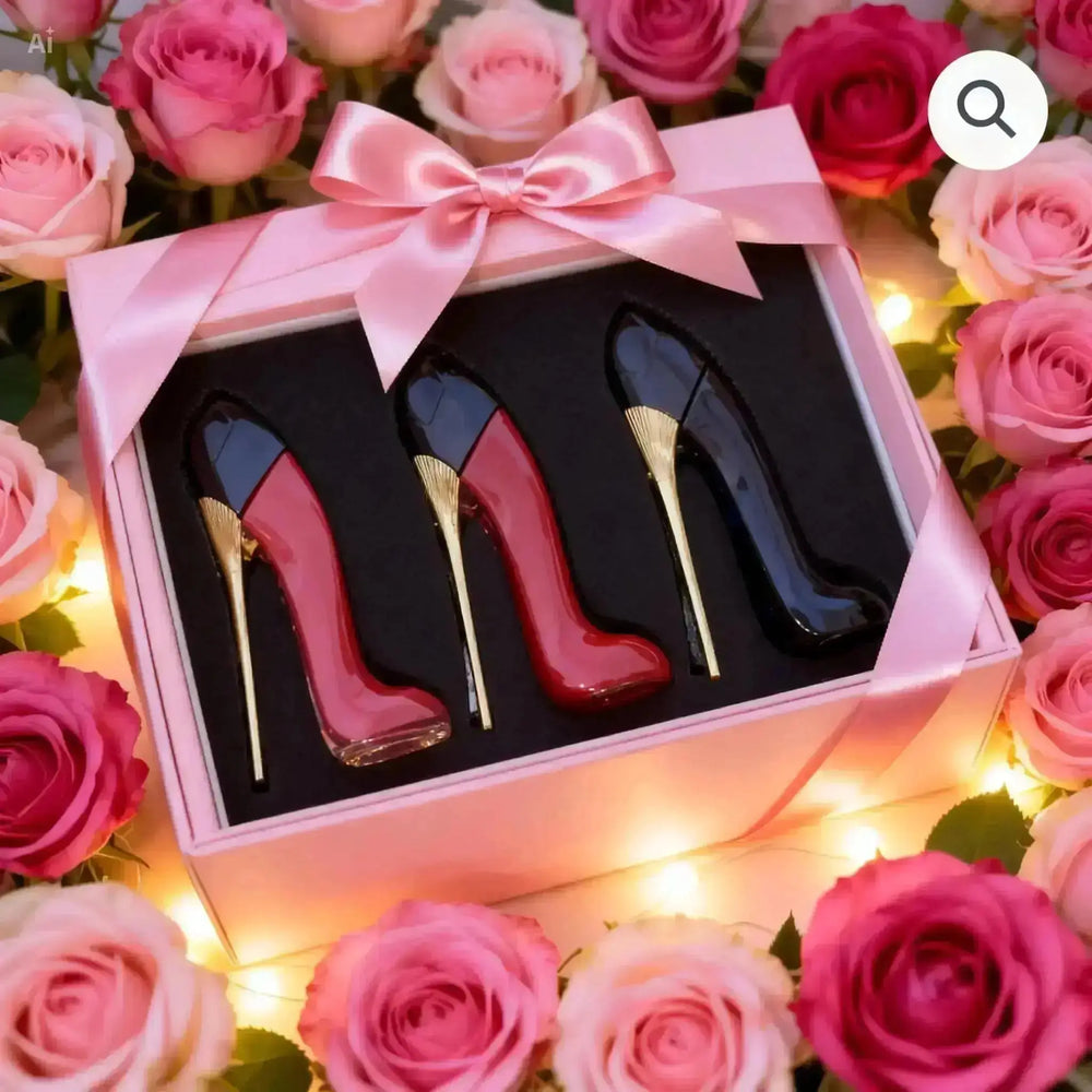 "Elegant 3-piece perfume set in stiletto-shaped bottles, red, black, and pink, presented in a pink box with a bow."