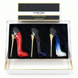 "Three stiletto-shaped perfume bottles in red, black, and blue, displayed in a clear box with a black velvet interior."