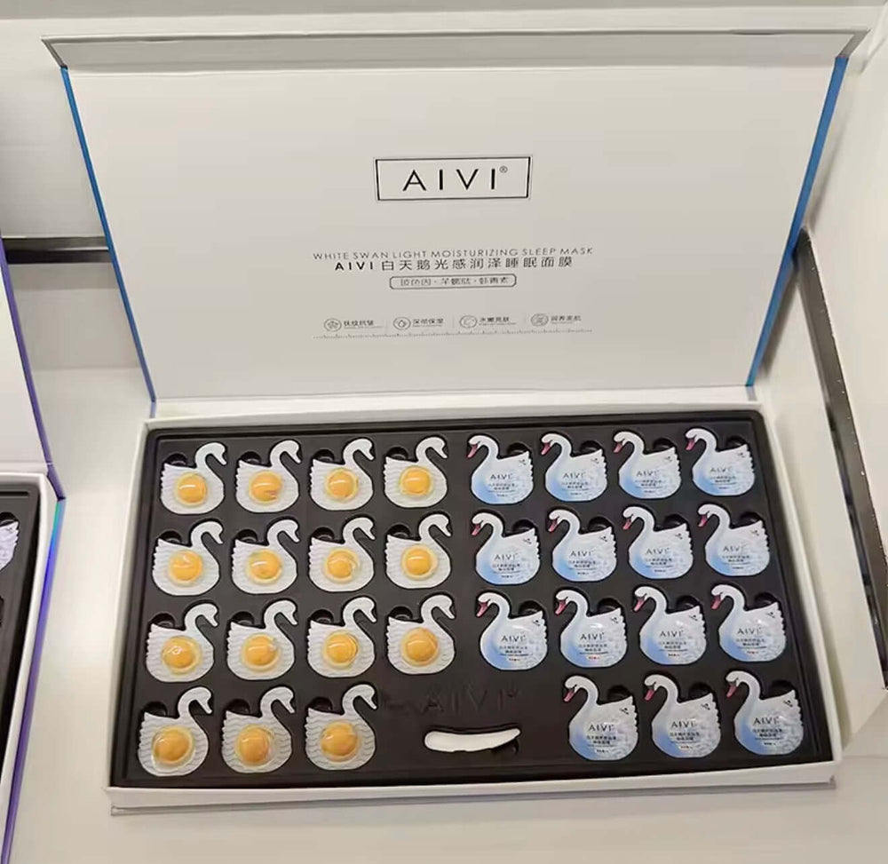 "Open box of AIVI Overnight Hydrating Capsules featuring white swan-shaped masks in a black foam insert."