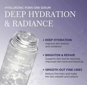 Clear glass serum bottle with a silver cap, featuring a label in blue and white text, placed against a soft purple background