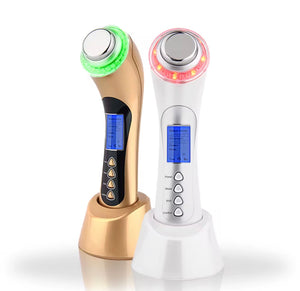 "Two ultrasonic facial devices, one gold with green light and one white with red light, both on charging bases."