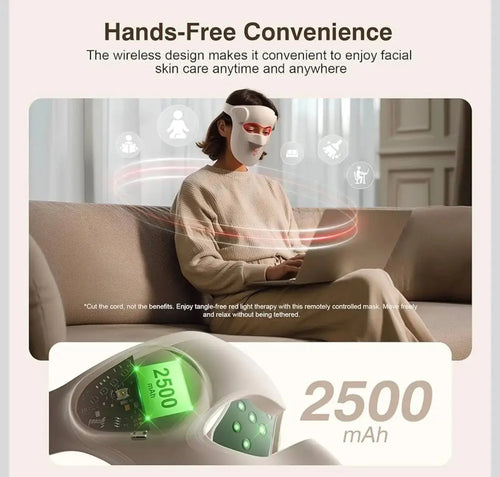 "White 3D LED light therapy mask with red accents, worn by a person sitting on a beige couch, holding a device."