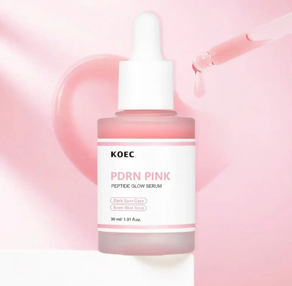 Pink glass serum bottle with a white dropper, featuring a label that reads "KOEC PDRN Pink Peptide Glow Serum," on a soft pin