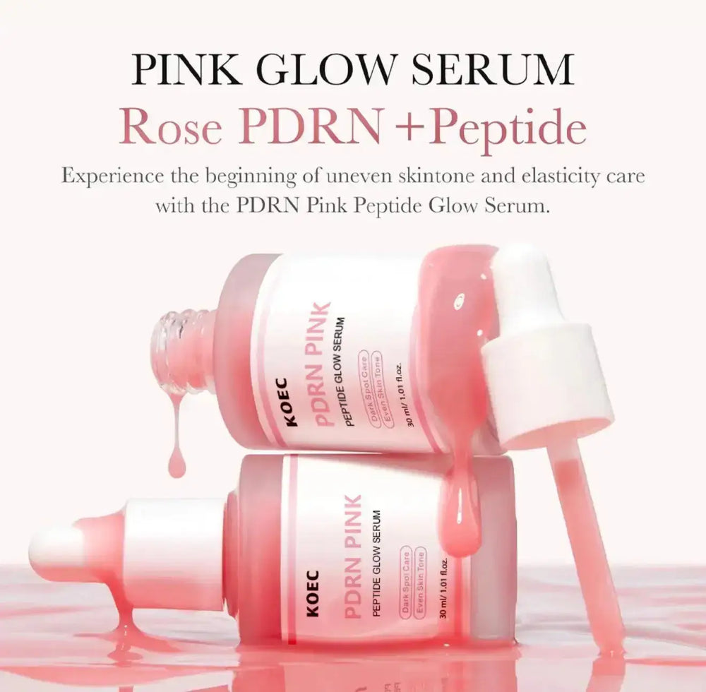"Two pink serum bottles with white caps, one tilted and dripping, against a light background."