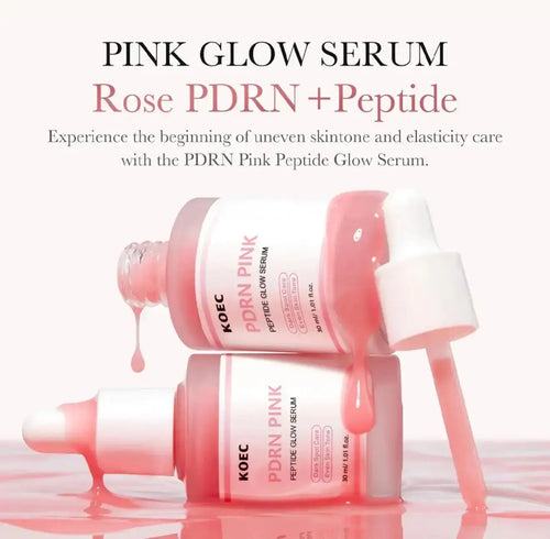 "Two pink serum bottles with white caps, one tilted and dripping, against a light background."