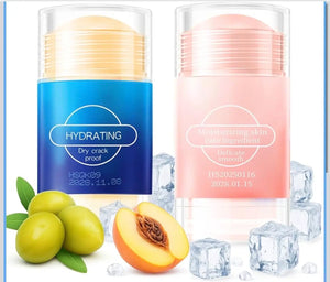 "Two balm sticks: one blue labeled 'HYDRATING' and one pink labeled 'Moisturizing skin care ingredient,' surrounded by olives
