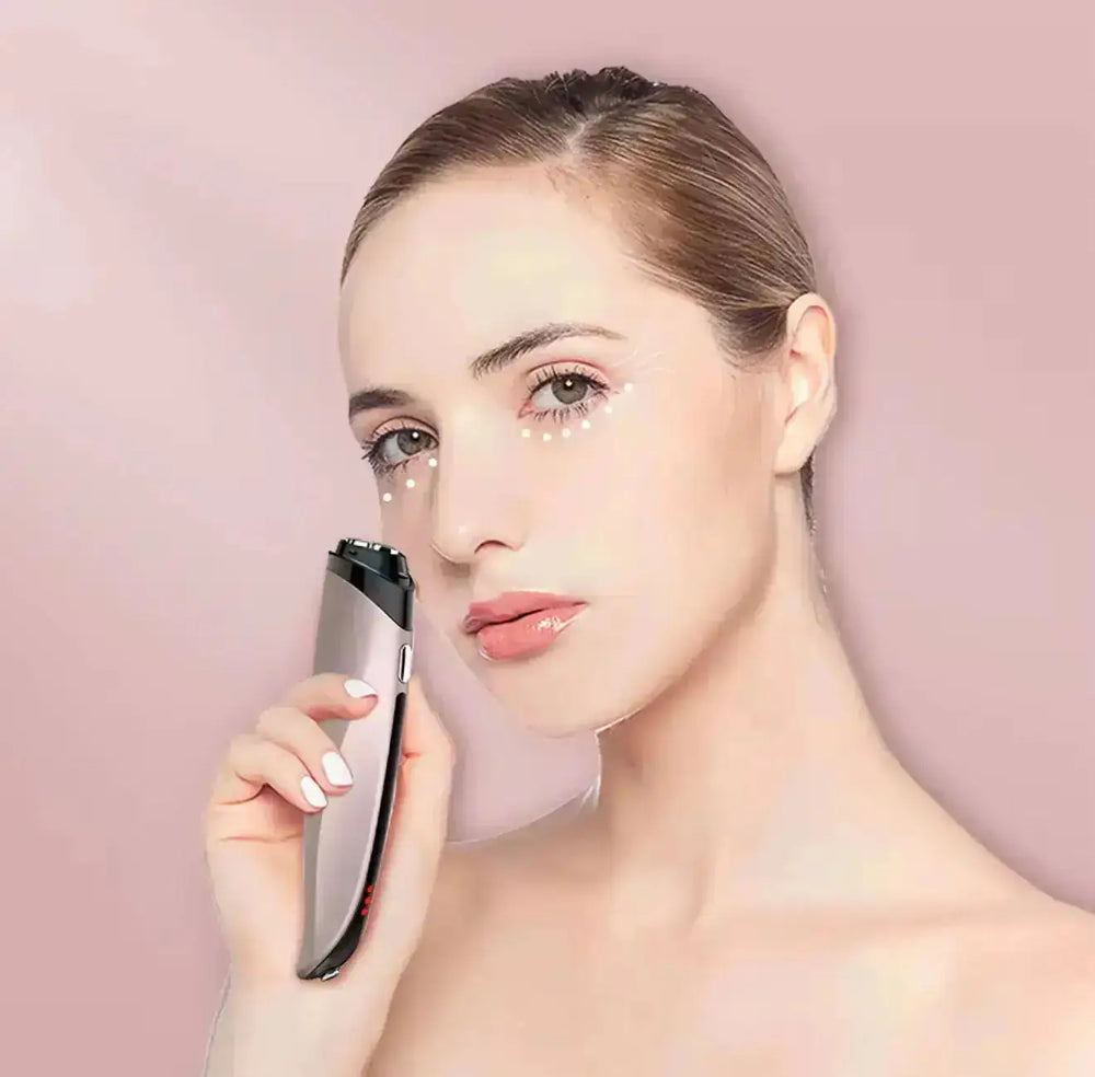 "Silver Beautivana Pulse Eye Care Device held against a woman's face, featuring LED lights and a sleek, ergonomic design."