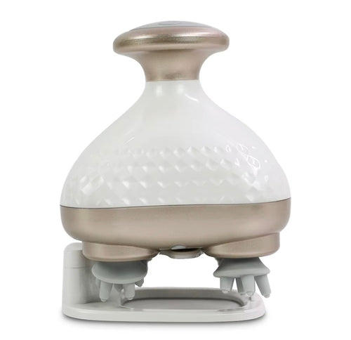 A handheld massage device with a glossy white textured upper body, a metallic champagne-gold handle and base band, and gray silicone massage nodes on a white charging dock, shown against a solid white background.