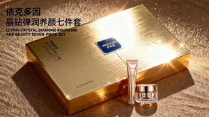 "Gold rectangular box with embossed logo, featuring a cream jar and a tube on glossy surface, angled view"