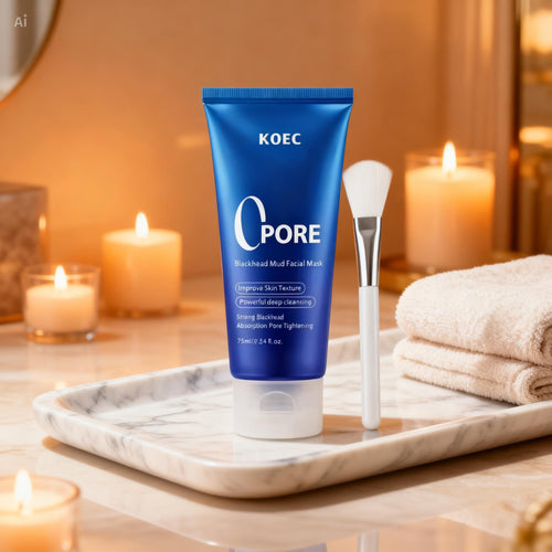 "Blue tube of KOEC Pore Detox Blackhead Mud Mask with white text, accompanied by a white brush on a marble tray."