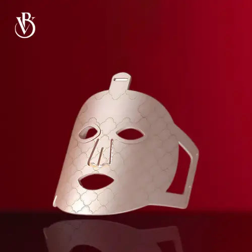 "7-Color LED light therapy mask in white with hexagonal pattern, featuring eye and mouth cutouts, angled view."