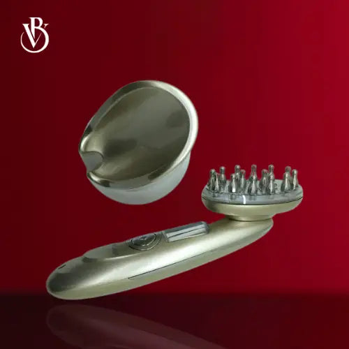 "Gold and white rechargeable electric scalp massager with round bristle head, angled view on a red background."