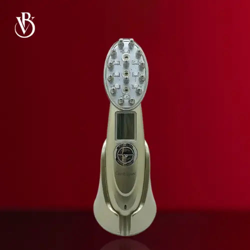 "Gold electric scalp massager with oval head, multiple massage nodes, and digital display, set against a red background."