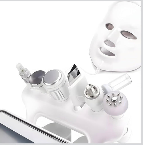 Close-up of treatment handpieces and LED mask included with hydro microdermabrasion facial machine