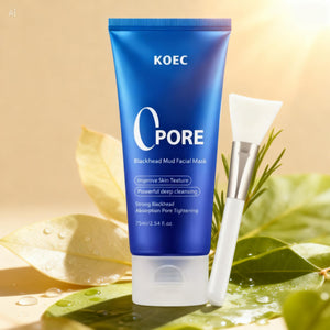 Blue tube of KOEC Pore Detox Blackhead Mud Mask with white cap and text, accompanied by a silicone applicator, on a leaf back