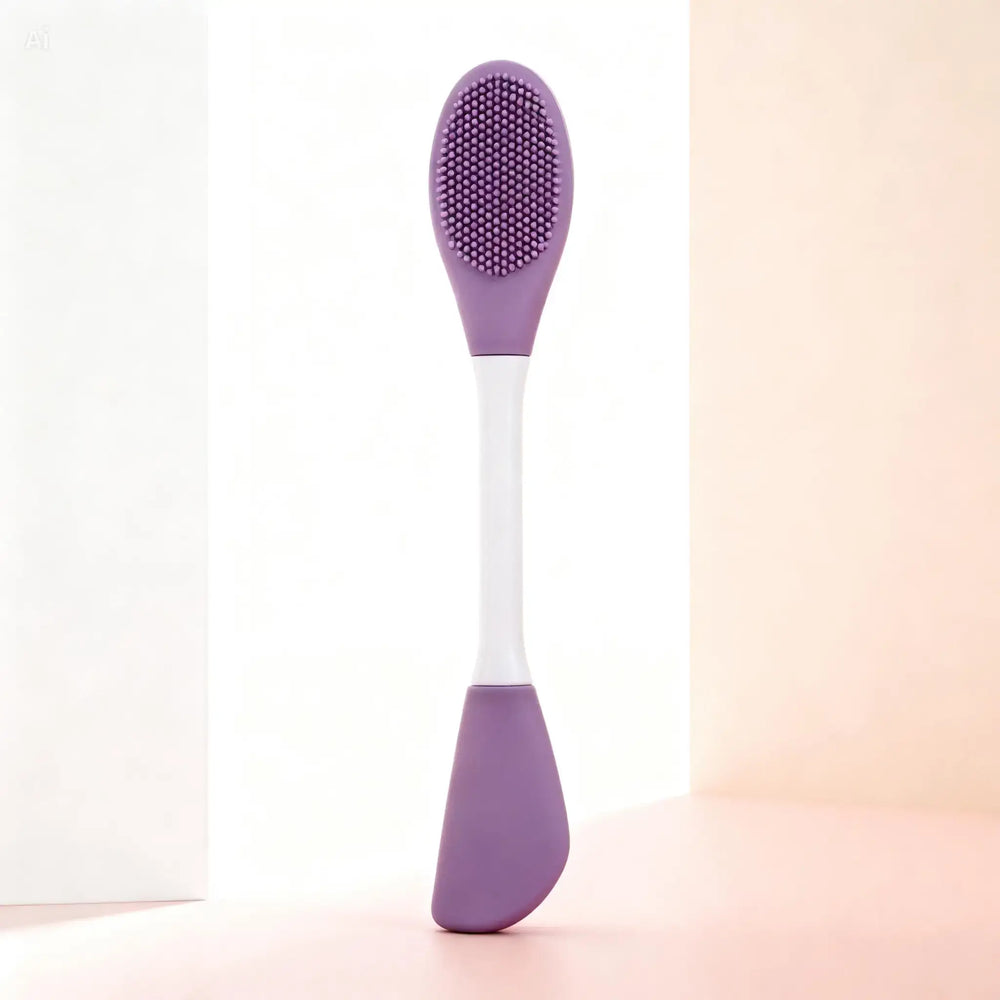 "Double-ended silicone exfoliating brush with a purple textured head and white handle, angled view on soft pastel background.